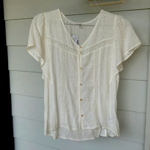 White top. Has little eyelet design.